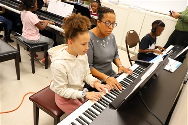 Students learning to play the piano