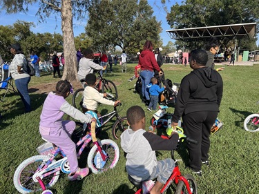 District 6 children on bikes in a park
